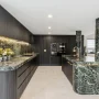 Modern kitKitchen renovations Sydneychen renovation with dark cabinetry and marble island bench, Sydney