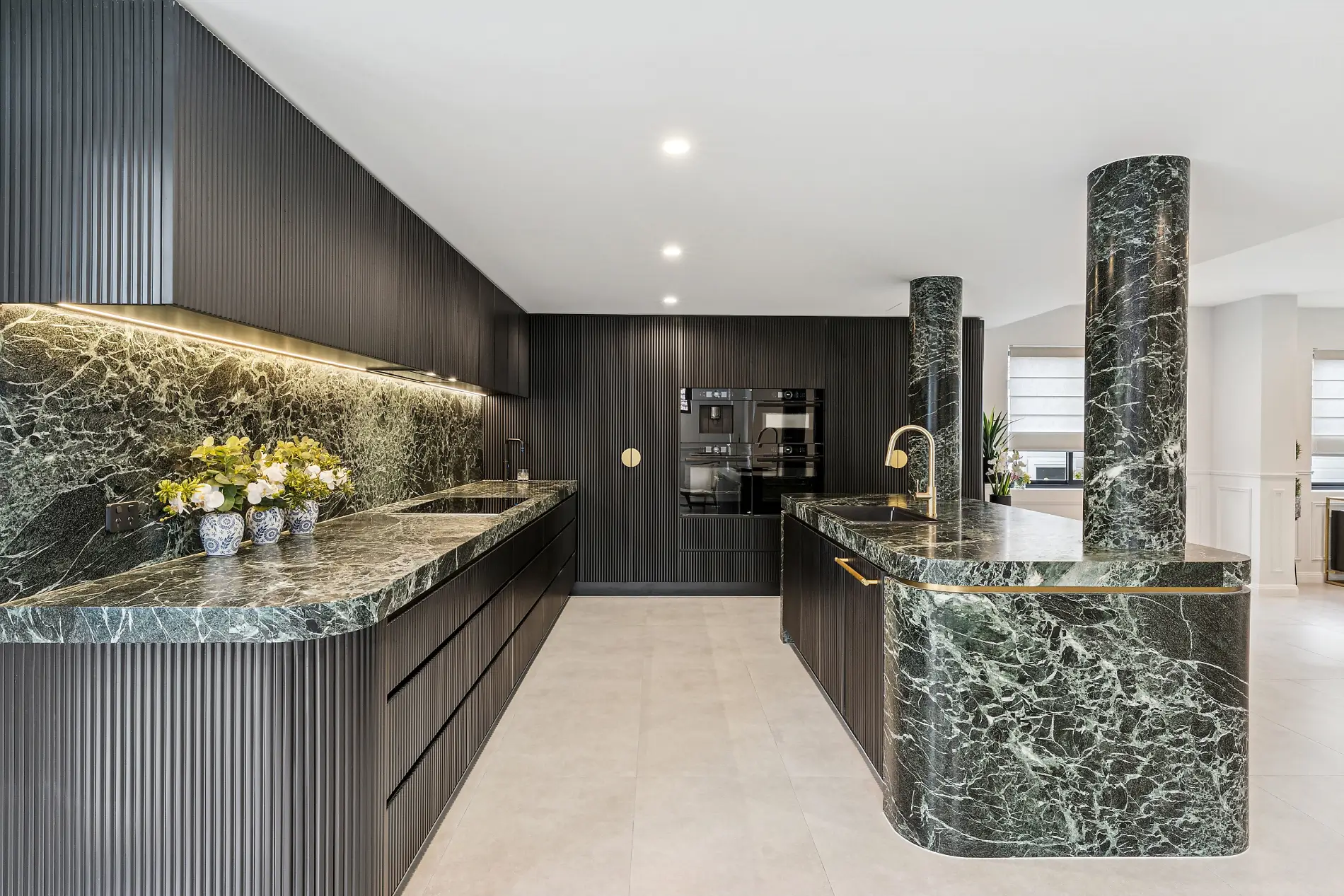 Modern kitchen renovation with dark cabinetry and marble island bench, Sydney